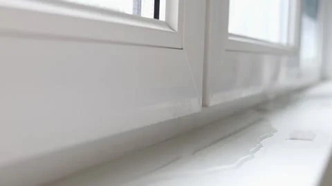 Close-up of window frame with leaking water, a puddle on the windowsill Stock Footage 288873709
