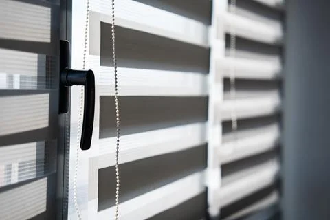 Close-Up of Window Handle and Zebra Blind Chain With Soft Light Photos