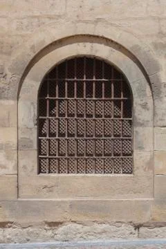 Close up Window with iron bar grill in stone wall Stock Photos