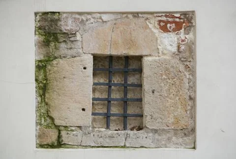 Close up Window with iron bar grill in stone wall Stock Photos