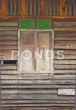 Close window of the old broken house Stock Photos
