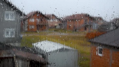 Close up of window pane during rainfall with water streaks Stock Footage 171612888