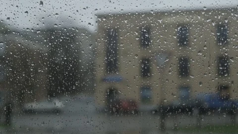 Close up of a window with rain drops falling down Stock Footage 106191017
