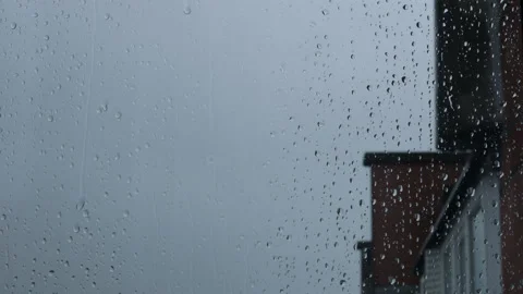 Close up of a window with rain drops falling down Stock Footage 180414219