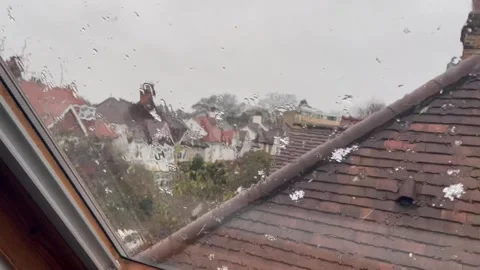 Close Up Window View of Snow Falling Softly Outside in Winter Stock Footage 342288513