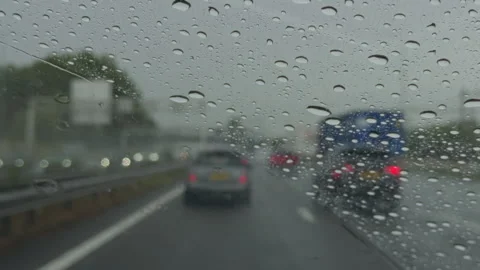 Close Up Windscreen View from Inside Car Driving on Highway in Rain with Wipers Stock Footage 345999825