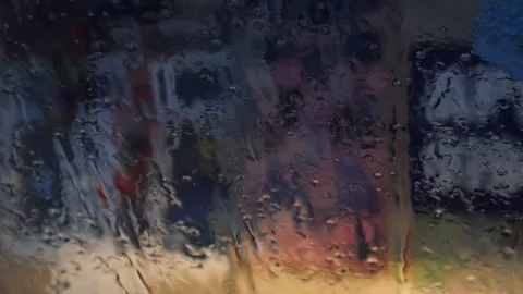 Up-Close Windshield While Snowing and Raining Outside. Water Melts and Beads Dow Stock Footage 101517602