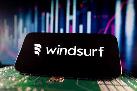 Close up of Windsurf logo on smartphone screen with financial chart background. Stock Photos