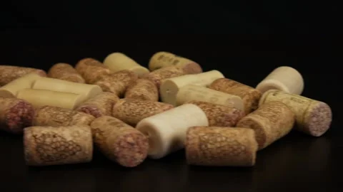 Close up of wine corks on black table. Camera moves from right to left Stock Footage 105745348