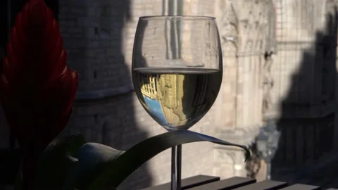 Close up of a wine glass filled with white wine on a Spanish balcony Stock Footage