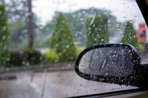 Close up of wing mirror at the car in the raining day. Stock Photos