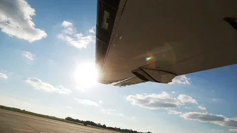 Close-up wing of the plane shines the sun on the airfield arrival aviation Video stock 99252875