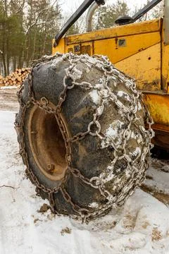 Close up of Winter Chains on Yellow Logging Skidder Stock Photos