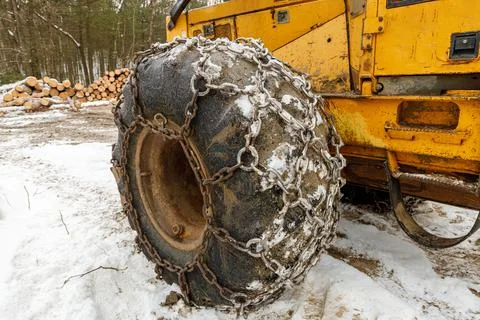 Close up of Winter Chains on Yellow Logging Skidder Stock Photos