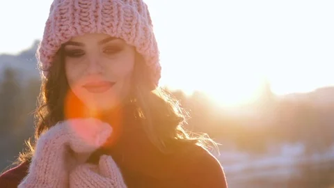 Close up Winter portrait of a young smiling woman in a pink hat and gloves Stock Footage 70048459