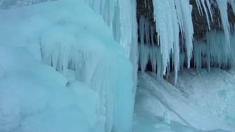 CLOSE UP: Winter wonderland in snowy mountains full of frozen sparkling icicles Stock Footage