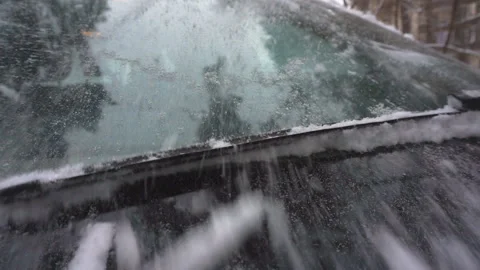 Close-up of wipers, throwing snow from the windshield of the car. Stock-Footage 99741000