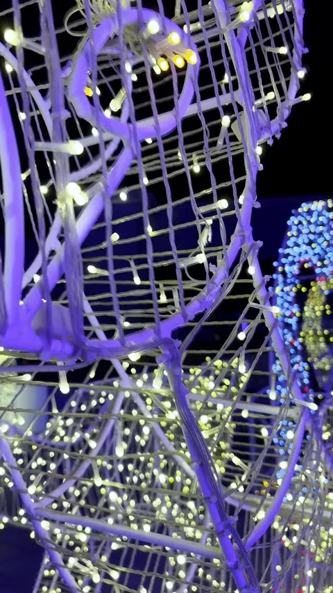 A close-up of a wire deer sculpture illuminated by fairy lights at night Stock Footage 321195855