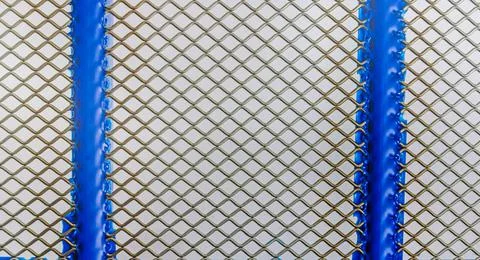 Close up of wire mesh with blue frame 写真素材