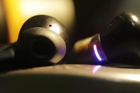 Close-up of wireless earbuds with LED light Stock Photos
