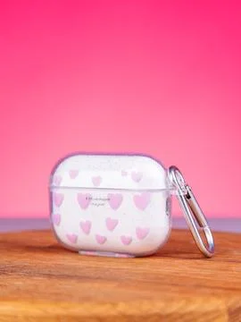 Close up of wireless headphone case with cute print on table Stock Photos