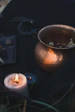 Close up witch cauldron and burning candle concept photo Stock-Fotos