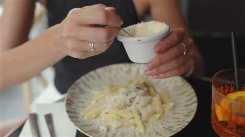 Close Up of Woman Adding Grated Cheese to Penne Pasta Stock Footage 344956729
