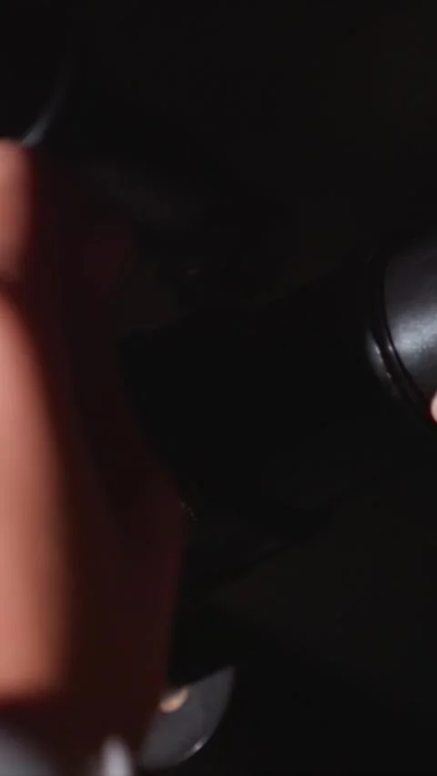 Close up of woman adjusting knobs and screws on technical equipment in dark 스톡 동영상 343081050