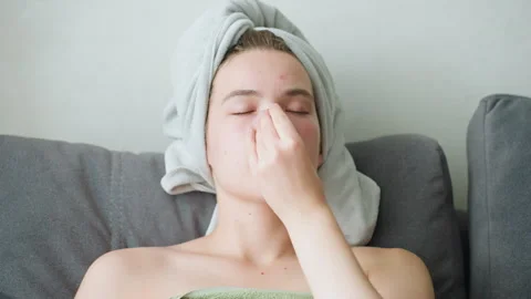 Close-Up of Woman Applying Cucumber Slice to Face for Skincare in Relaxing Stock Footage 308591532