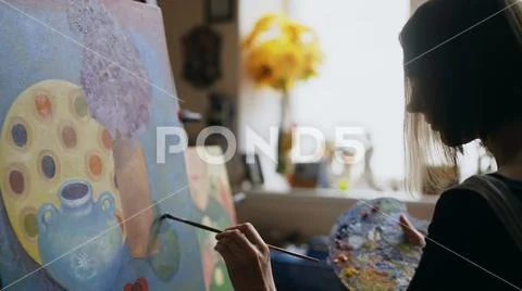 Close-up of woman artist painting still life picture on canvas in art studio Stock Photos