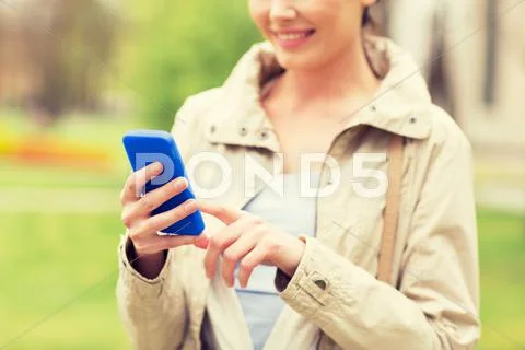 Close Up Of Woman Calling On Smartphone In Park