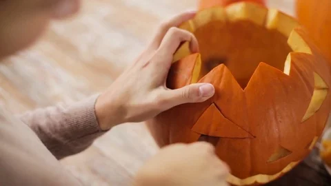 Close up of woman carving halloween pumpkin Stock Footage