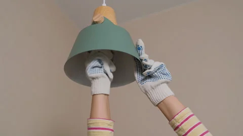 Close-up of woman changes light bulb at home Stock Footage 317321584