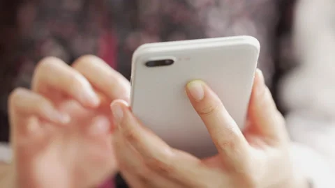 Close up Woman checking email with mobile phone at a coffee shop Stock Footage 152609827
