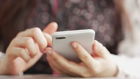 Close up Woman checking email with mobile phone at a coffee shop Stock Footage 152610336