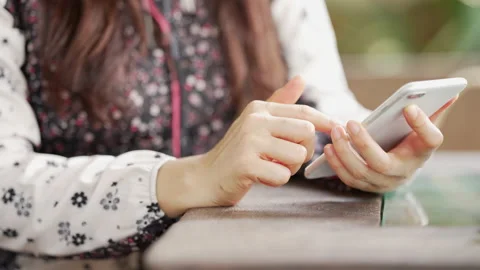 Close up Woman checking email with mobile phone at a coffee shop Stock Footage 152610365