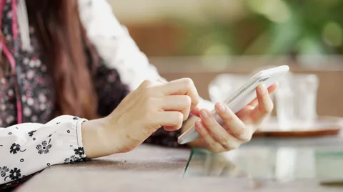 Close up Woman checking email with mobile phone at a coffee shop Stock Footage 152610597
