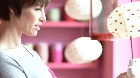 Close-up of woman choosing pottery in shop Stock Footage 106324344