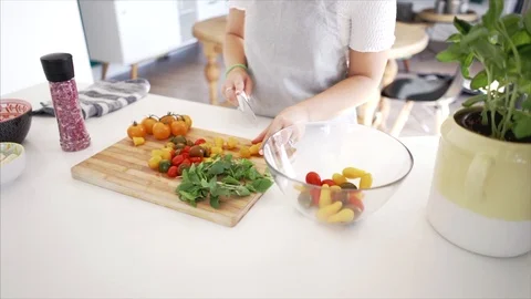 Close-up of woman cutting tomatoes with sharp knife Stock Footage 91170869