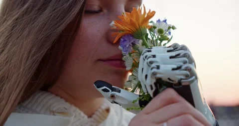 Close up of a woman with a disability holding a bouquet of flowers with a bionic Stock Footage