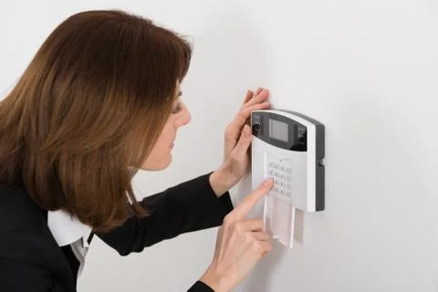 Close-up Of Woman Entering Code In Security System Stock Photos