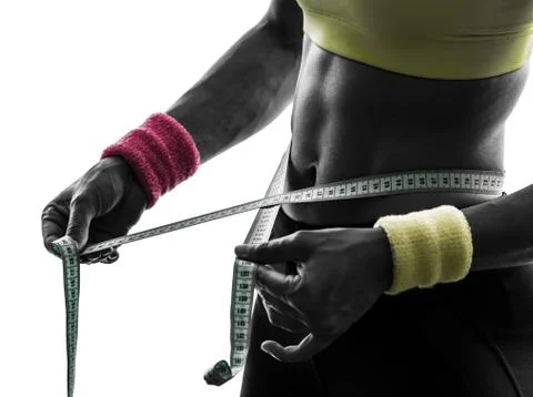 Close up woman exercising fitness measuring  tape measure  silhouette Stock Photos