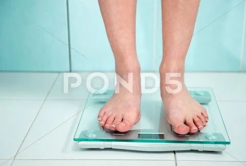 Close up of woman feet weighing in bathroom Stock Photos