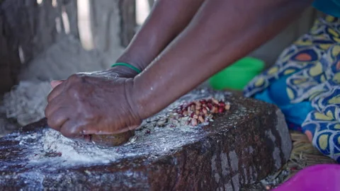 A close up of a woman grinding beans into a paste Stock Footage 254800498