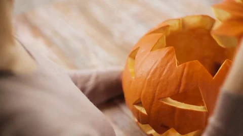 Close up of woman with halloween pumpkin at home Stock Footage