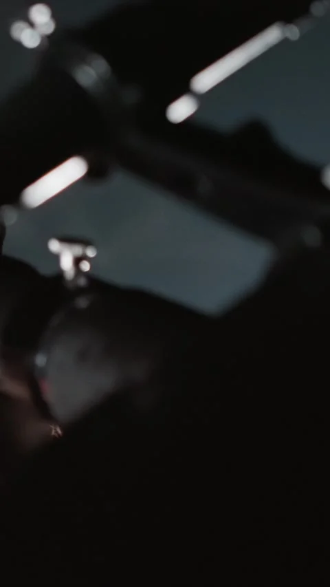 Close up of woman hand adjusting knobs on telescope and camera equipment in dim Stock-Footage 343079847