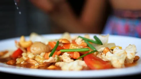Close up of woman hand eats stir fried chicken, vegetables with cashews. HD. Stock-Footage 44050526