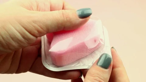 Close up of woman hand holding menstrual sponge in package and compressing Stock Footage
