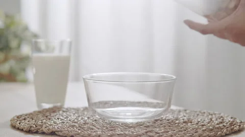 Close up of Woman hand is preparing corn flakes or  cereal Stock Footage 136469813