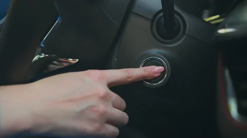 Close up woman hand push the button engine start in the car Stock Footage